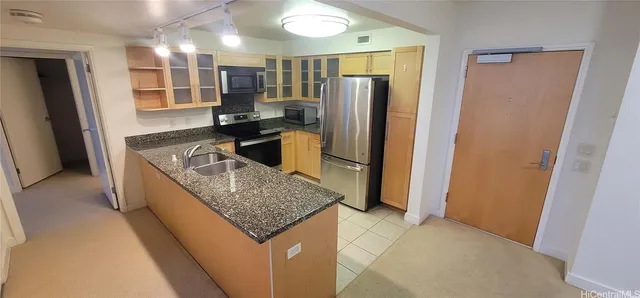 a kitchen with stainless steel appliances granite countertop a refrigerator and a sink