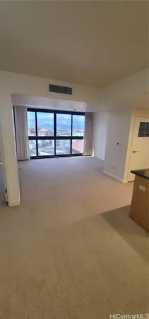 a view of a big room with windows and chandelier