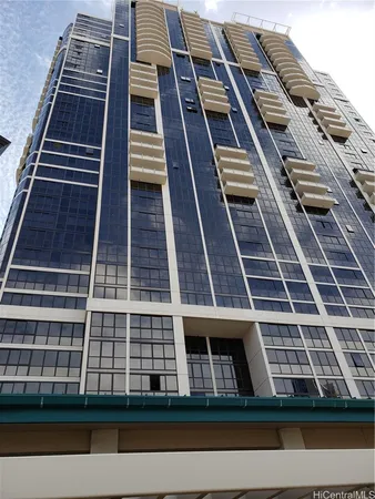 a front view of a building with plants