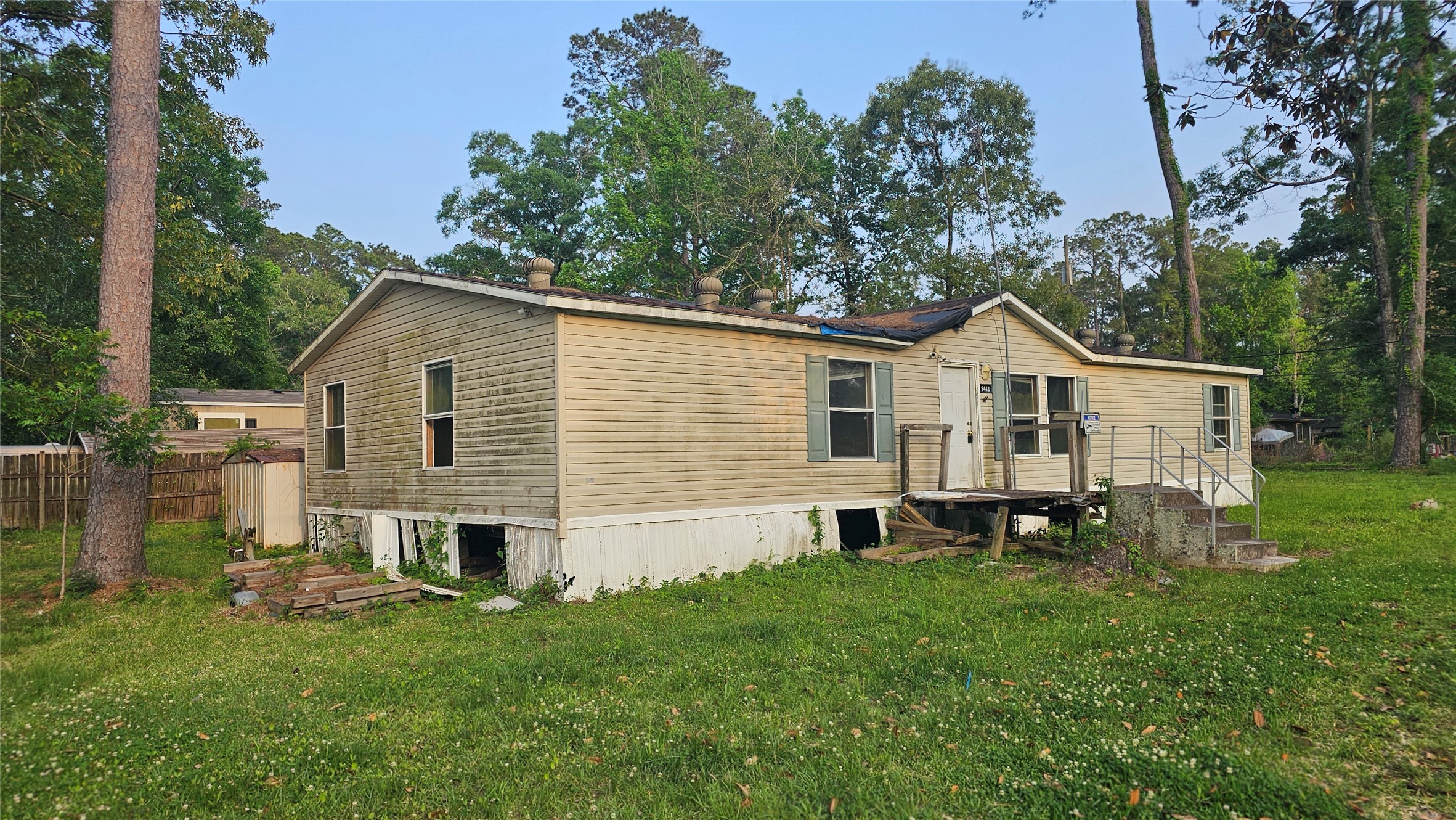 9443 1st Street Lumberton, TX 77657 - Photo 1 of 7 a front view of a house with a garden and chairs
