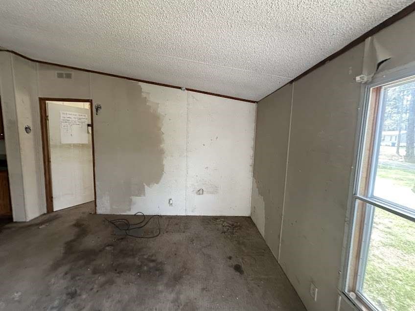 9443 1st Street Lumberton, TX 77657 - Photo 3 of 7 an empty room with a empty space and windows