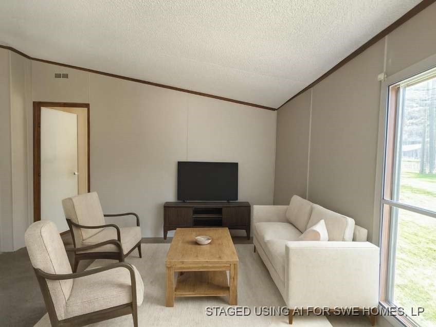 9443 1st Street Lumberton, TX 77657 - Photo 4 of 7 a living room with furniture and a flat screen tv