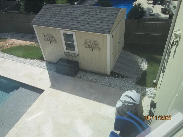 a front view of a house with wooden fence