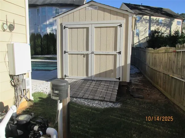 a backyard of a house with lots of green space and wooden fence