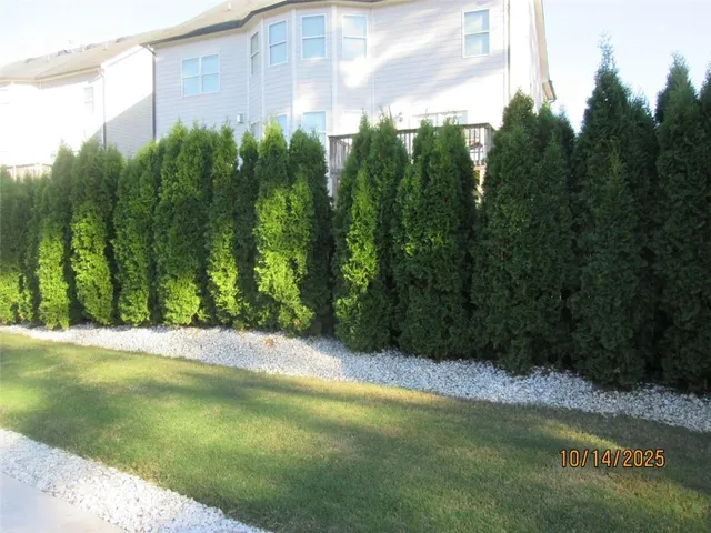 a living room with furniture and floor to ceiling windows