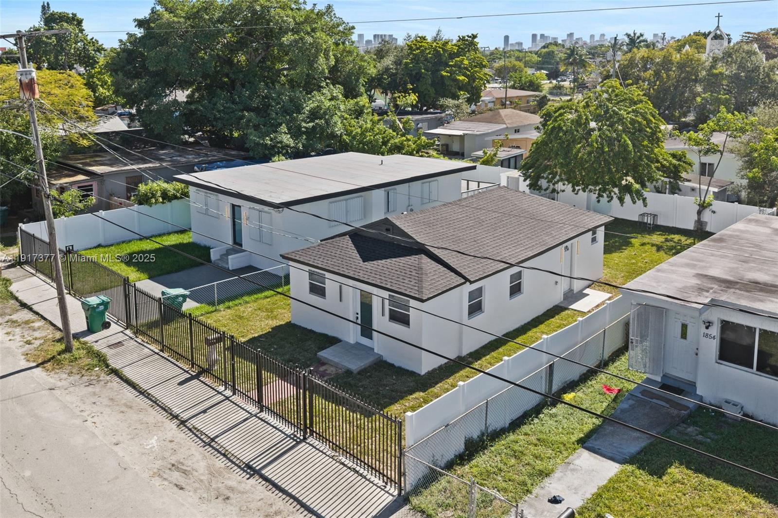 1844 Northwest 67th Street Miami, FL 33147 - Photo 2 of 27 a view of a patio with table and chairs a barbeque