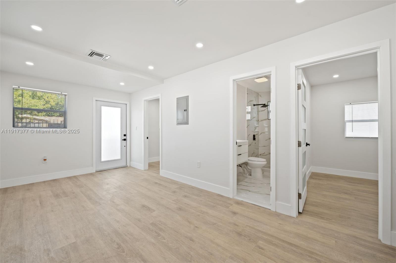 1844 Northwest 67th Street Miami, FL 33147 - Photo 8 of 27 an empty room with wooden floor and windows