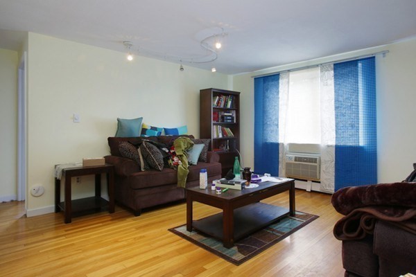 71 Colborne Road, Unit 1B Boston, MA 02135 - Photo 2 of 7 a living room with furniture and wooden floor