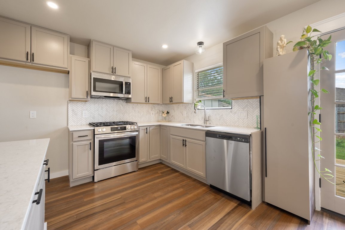 206 Jan Lane Georgetown, TX 78626 - Photo 7 of 23 a kitchen with stainless steel appliances a refrigerator sink and microwave