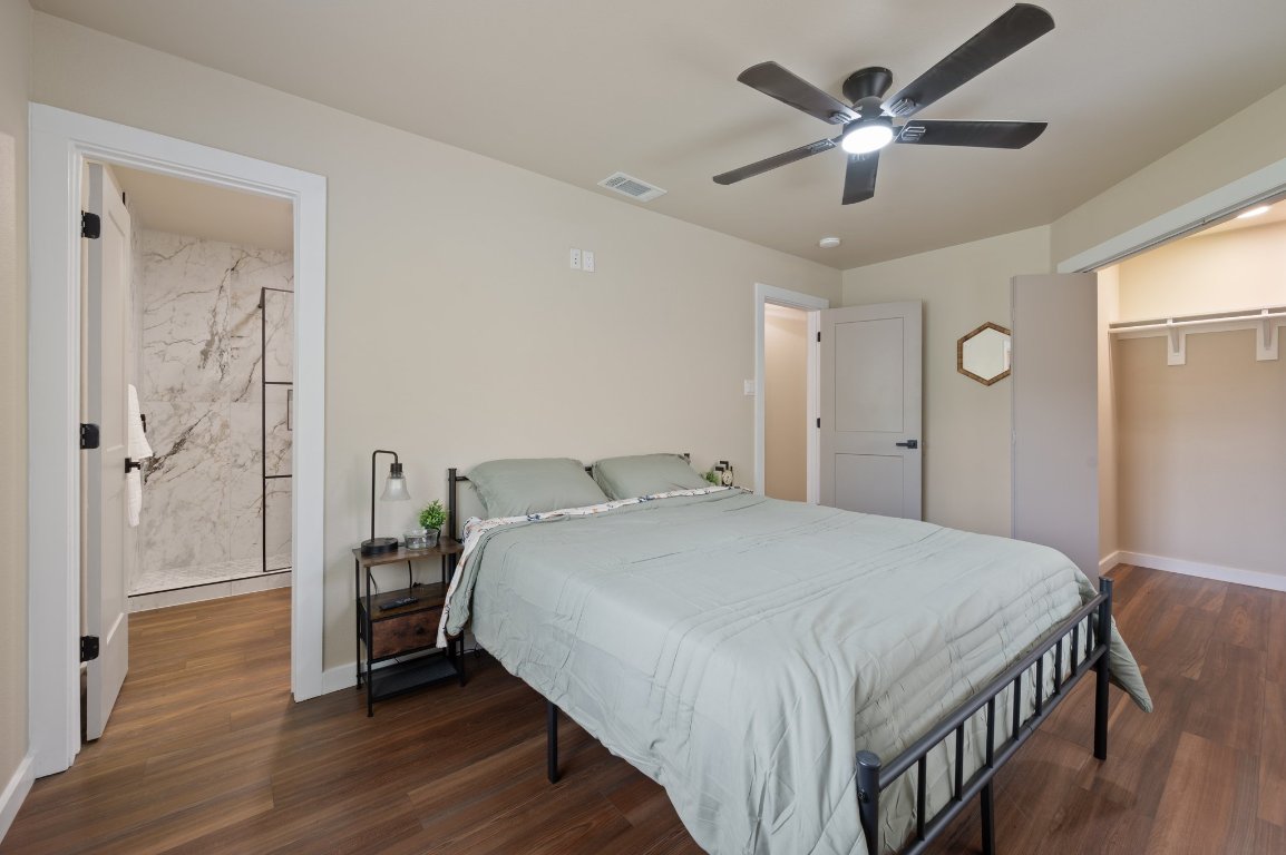 206 Jan Lane Georgetown, TX 78626 - Photo 10 of 23 a bedroom with a bed and a chandelier