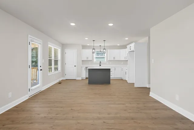a view of a kitchen with a sink and cabinets