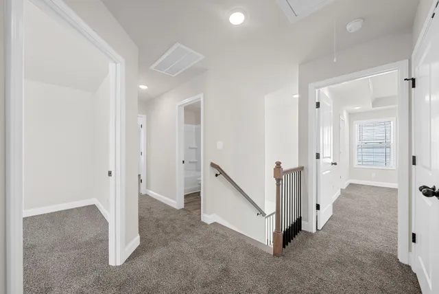 a view of a hallway with white walls