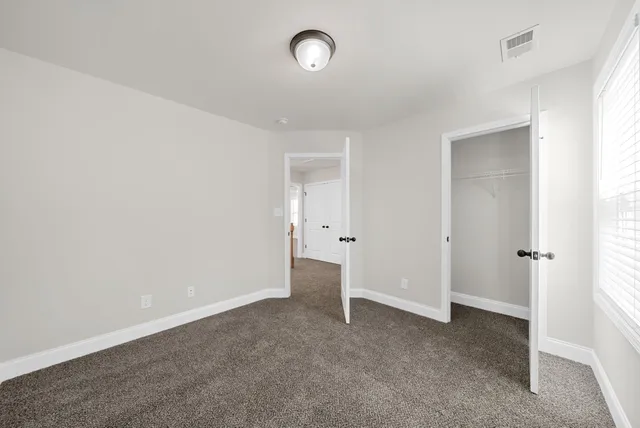 a view of an empty room with a closet