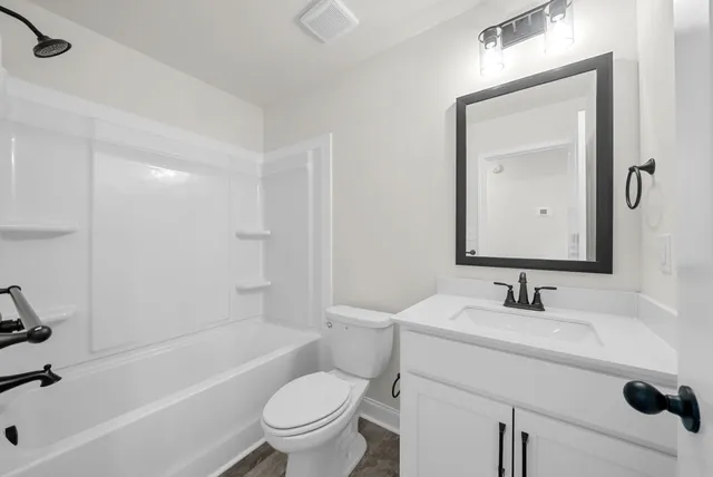 a bathroom with a sink toilet and a bathtub