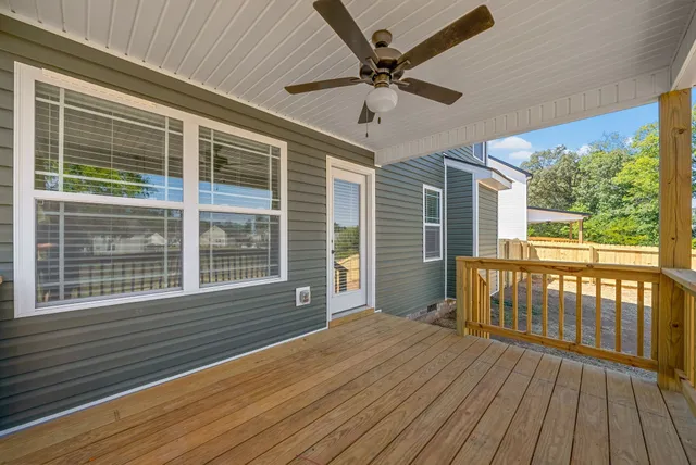 a view of a deck with wooden floor and a ceiling fan