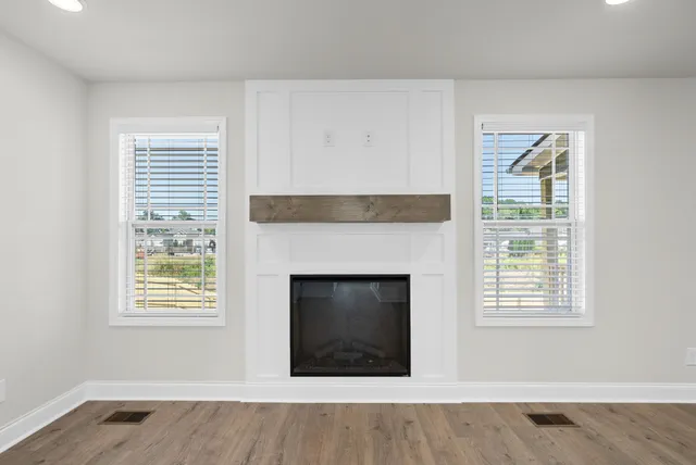 a living room with a fireplace and a window