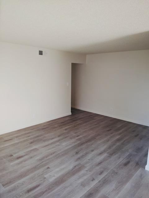 5960 Walerga Road, Unit 4 Sacramento, CA 95842 - Photo 4 of 9 a view of an empty room with wooden floor