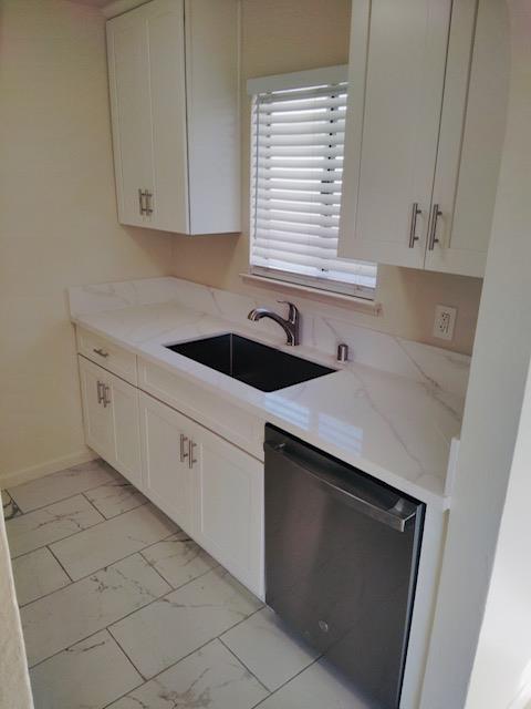 5960 Walerga Road, Unit 4 Sacramento, CA 95842 - Photo 6 of 9 a kitchen with a sink and cabinets