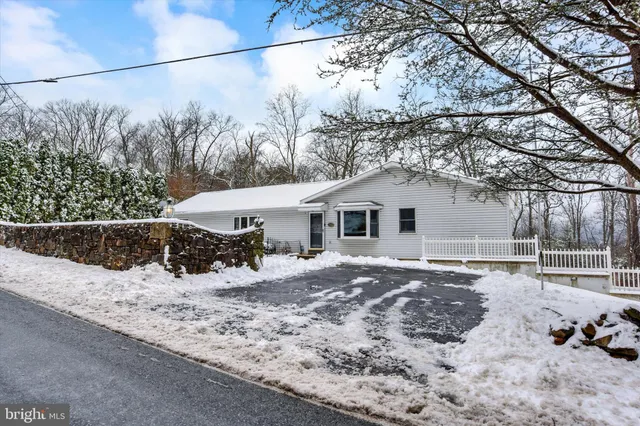 a view of a house with a yard covered in snow