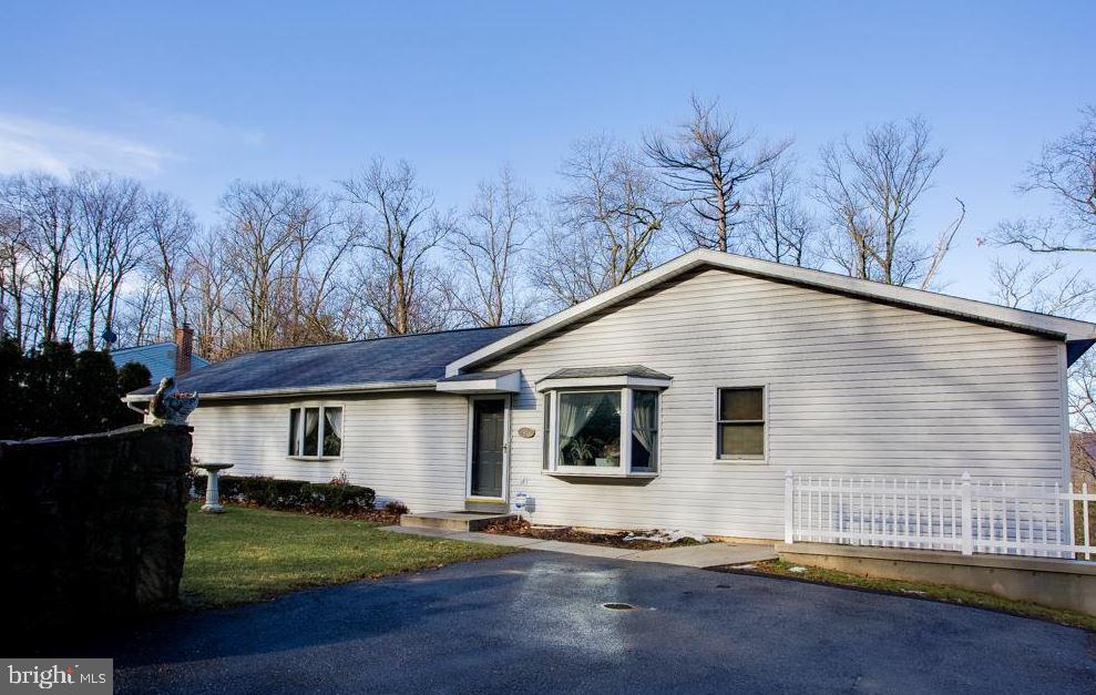 a view of a white house with a yard