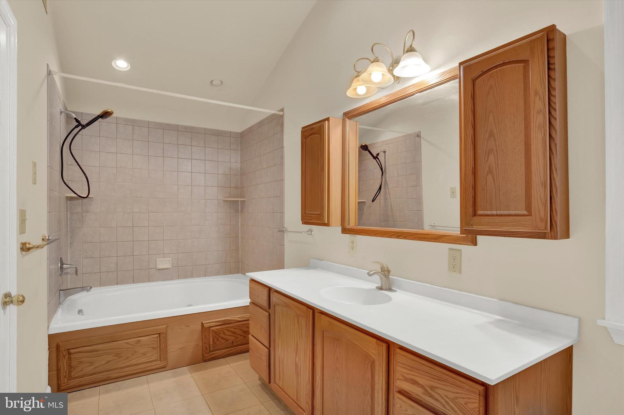 1336 Piketown Road Harrisburg, PA 17112 - Photo 12 of 29 a bathroom with a sink vanity granite tub and a mirror