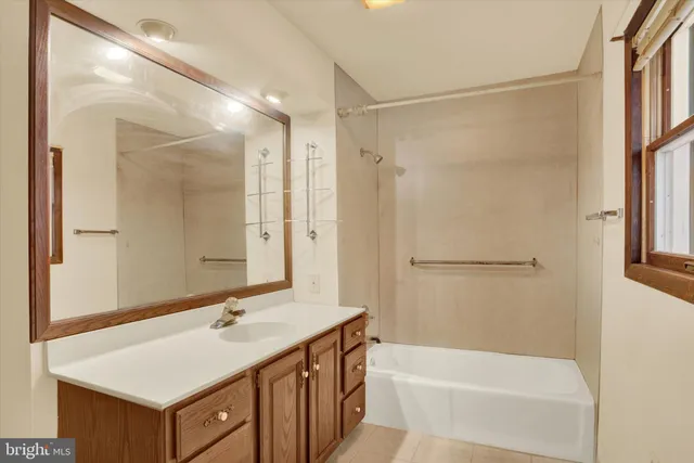 a bathroom with a shower curtain and a window