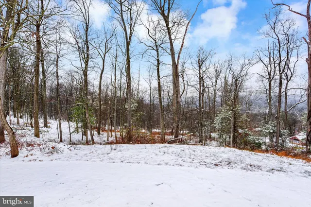 a view of a house with a yard covered with snow in front of house