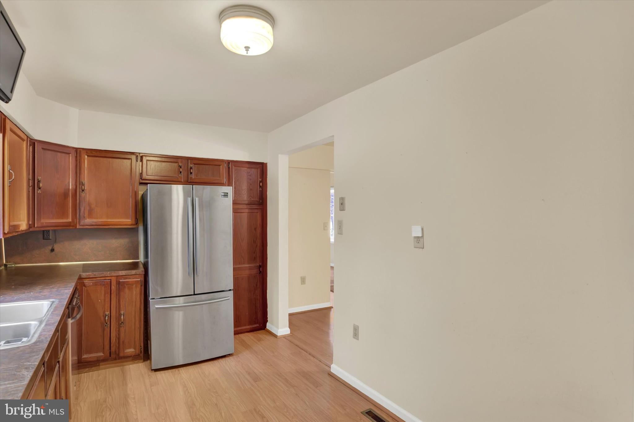 1336 Piketown Road Harrisburg, PA 17112 - Photo 7 of 29 a view of a kitchen with a refrigerator a stove top oven and cabinets