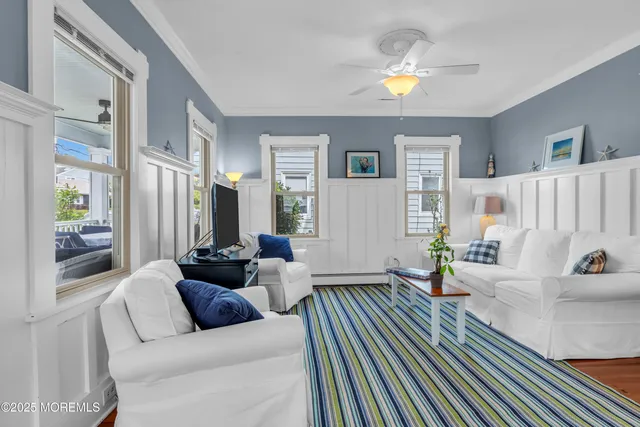 a living room with furniture and a chandelier