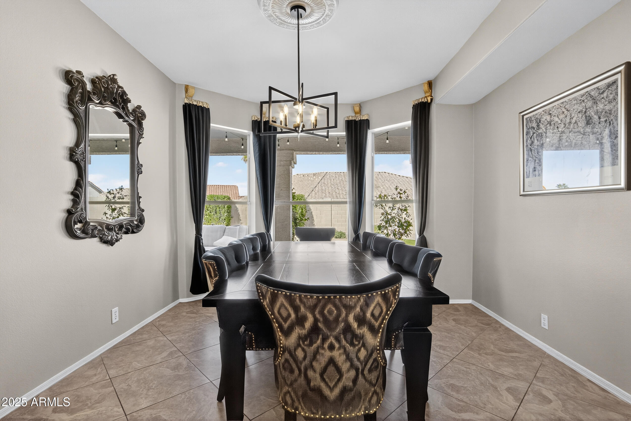 1614 East Kathleen Road Phoenix, AZ 85022 - Photo 6 of 30 a dining room with furniture large windows and a chandelier