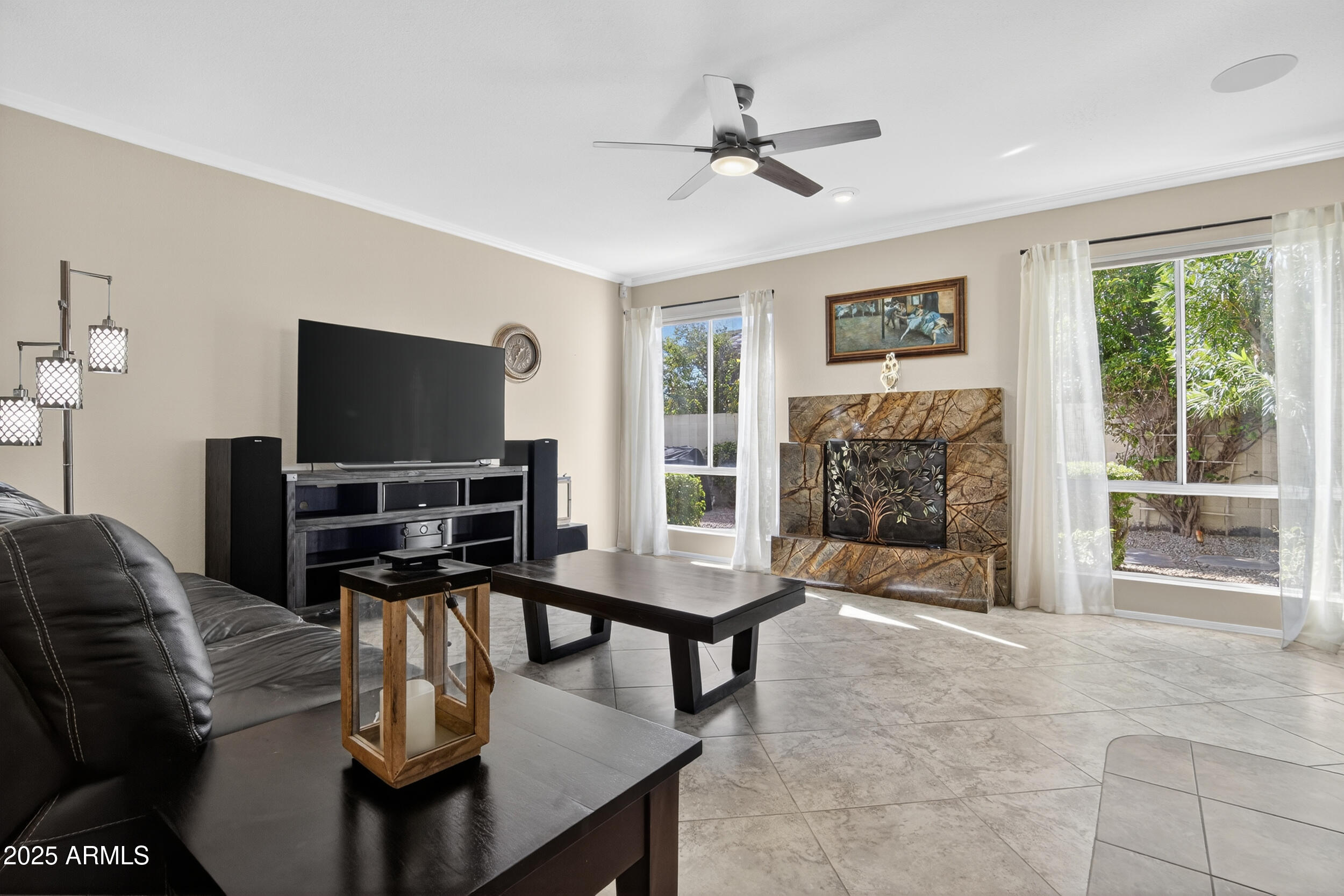 1614 East Kathleen Road Phoenix, AZ 85022 - Photo 8 of 30 a living room with furniture a fireplace and a flat screen tv