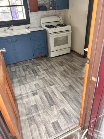 a kitchen with a stove and cabinets