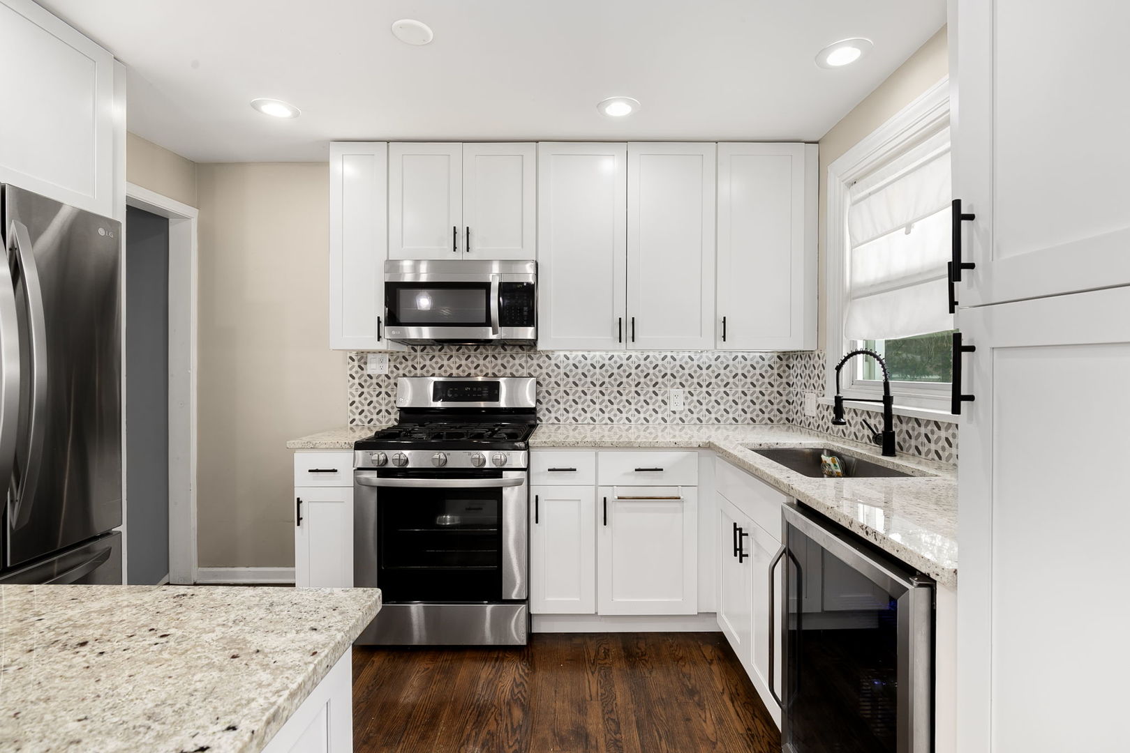 4237 Park Avenue Brookfield, IL 60513 - Photo 7 of 20 a kitchen with stainless steel appliances granite countertop a stove top oven a sink and a microwave