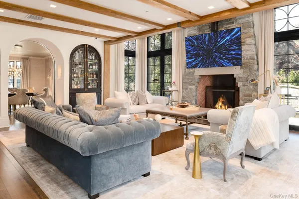 a living room with furniture a fireplace and a large window