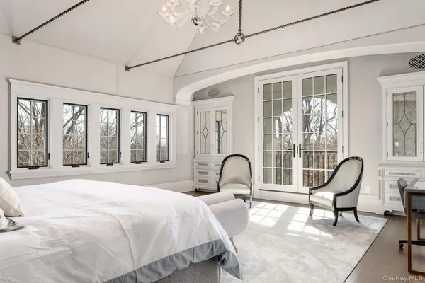 a bedroom with a bed and a large window