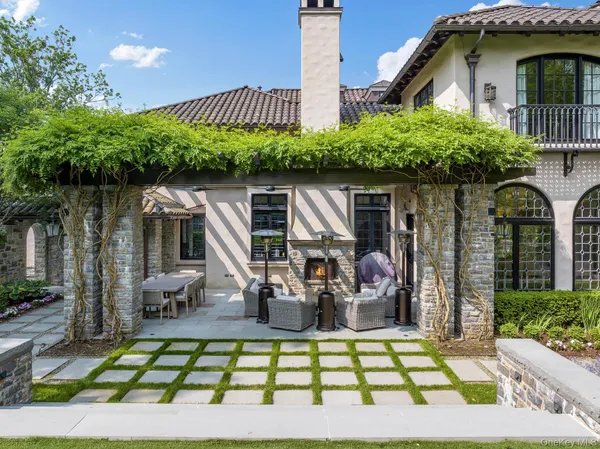 a front view of a house with a yard and potted plants