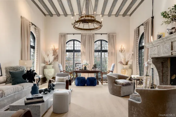 a living room with fireplace furniture and a chandelier