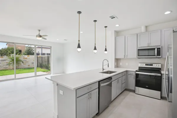 a kitchen with a sink stove and oven