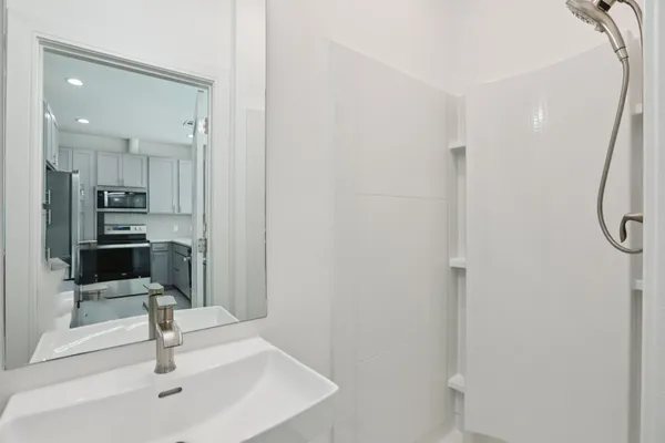 a view of a bathroom with a sink and mirror