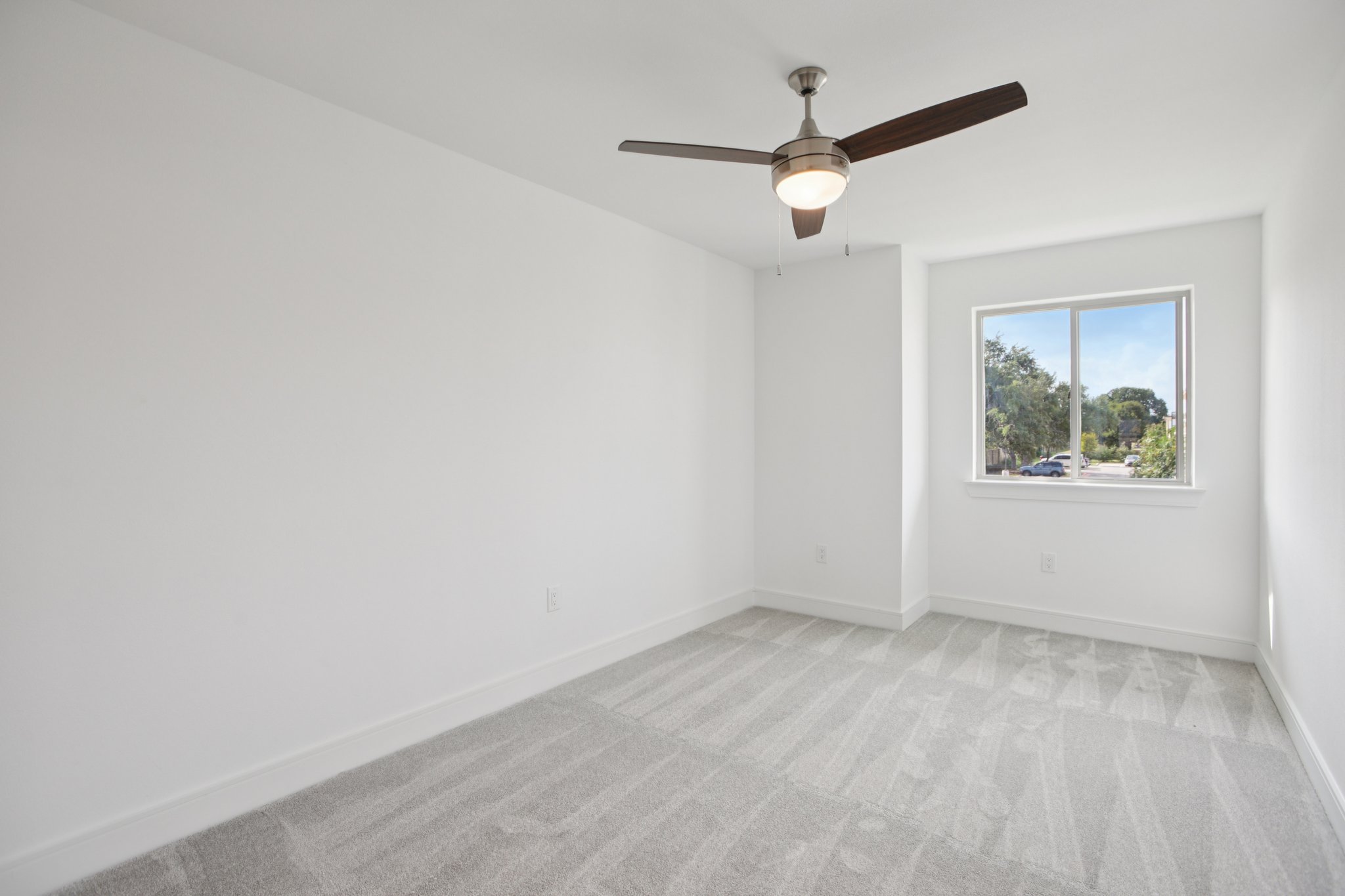 202 Tesla Circle Austin, TX 78681 - Photo 20 of 35 an empty room with a window and a ceiling fan