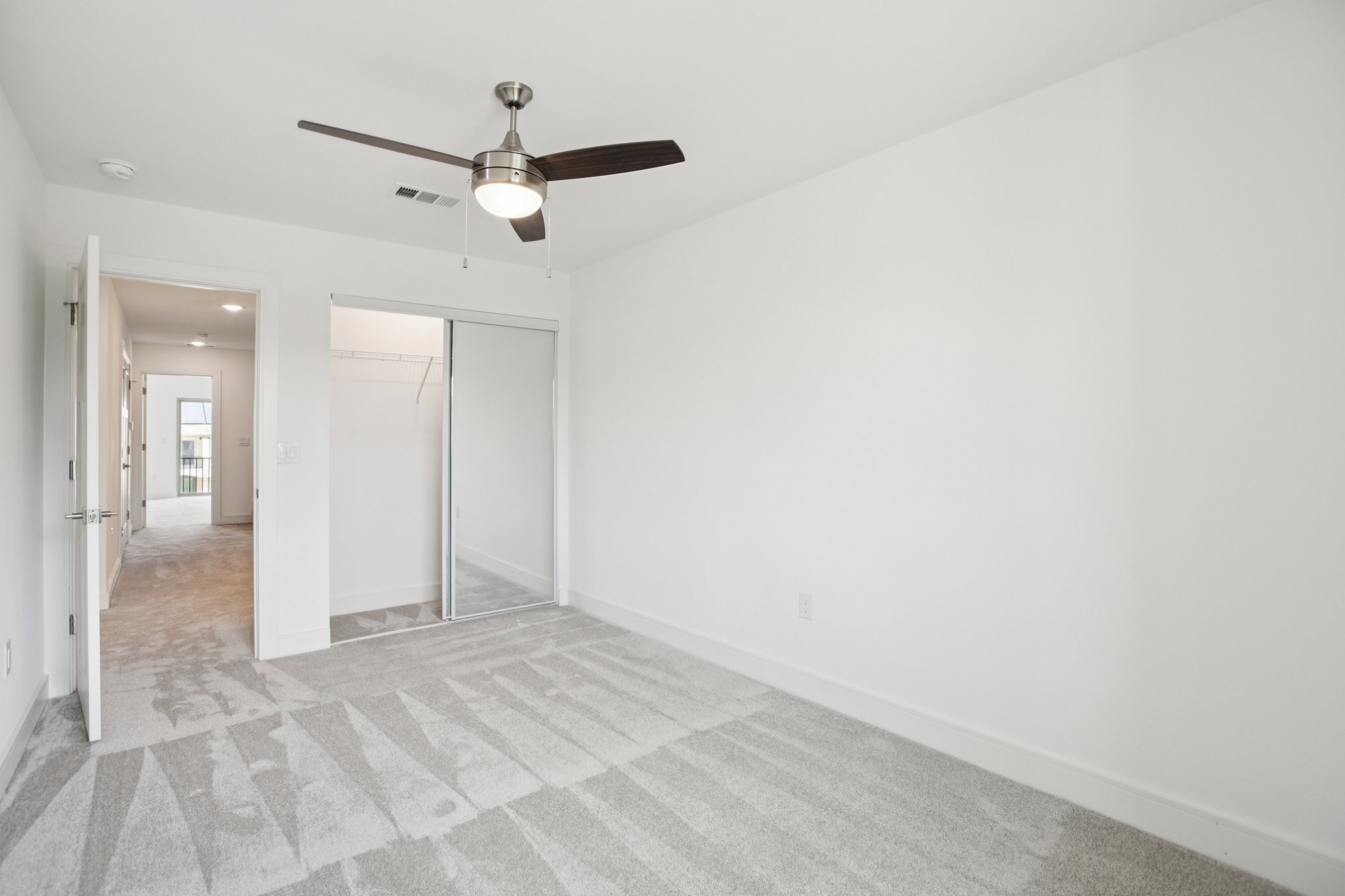 202 Tesla Circle Austin, TX 78681 - Photo 22 of 35 an empty room with a white cabinet and a ceiling fan