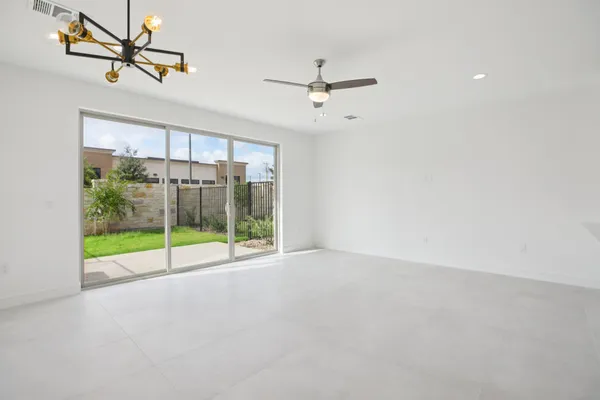 a view of room with window and ceiling fan