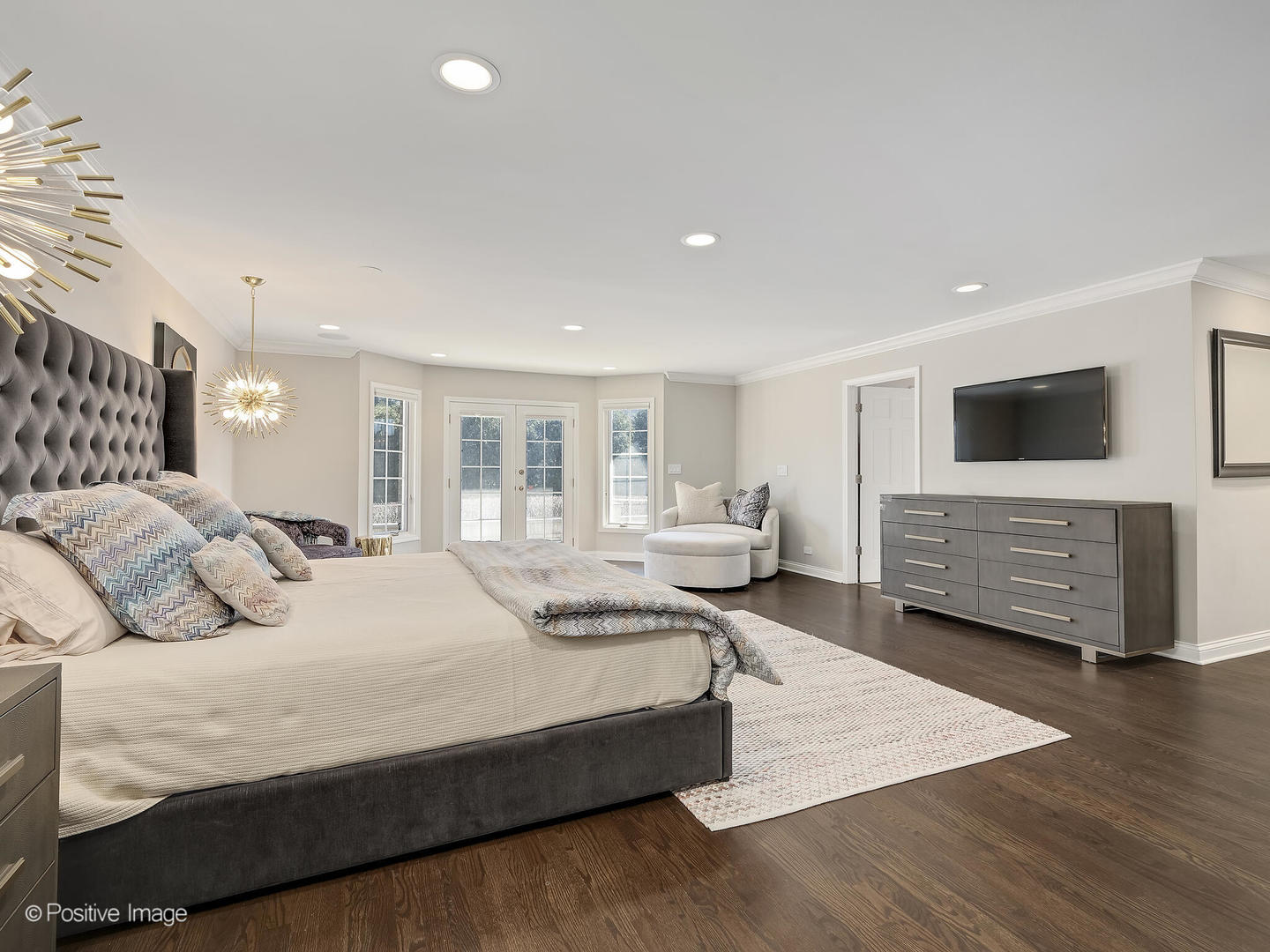 8151 Lake Ridge Drive Burr Ridge, IL 60527 - Photo 21 of 46 a spacious bedroom with a bed and a flat screen tv