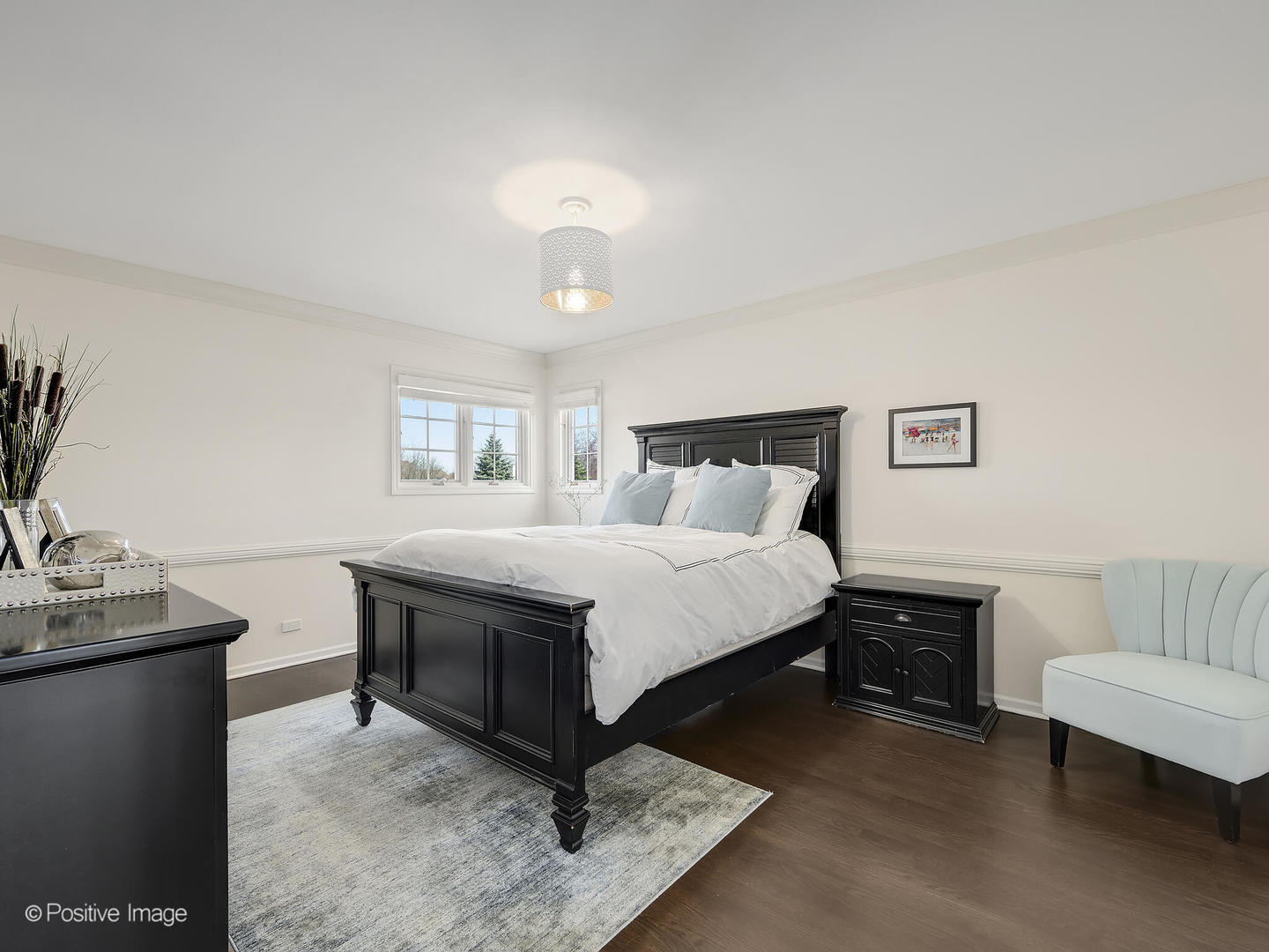 8151 Lake Ridge Drive Burr Ridge, IL 60527 - Photo 26 of 46 a bedroom with a bed and a chandelier