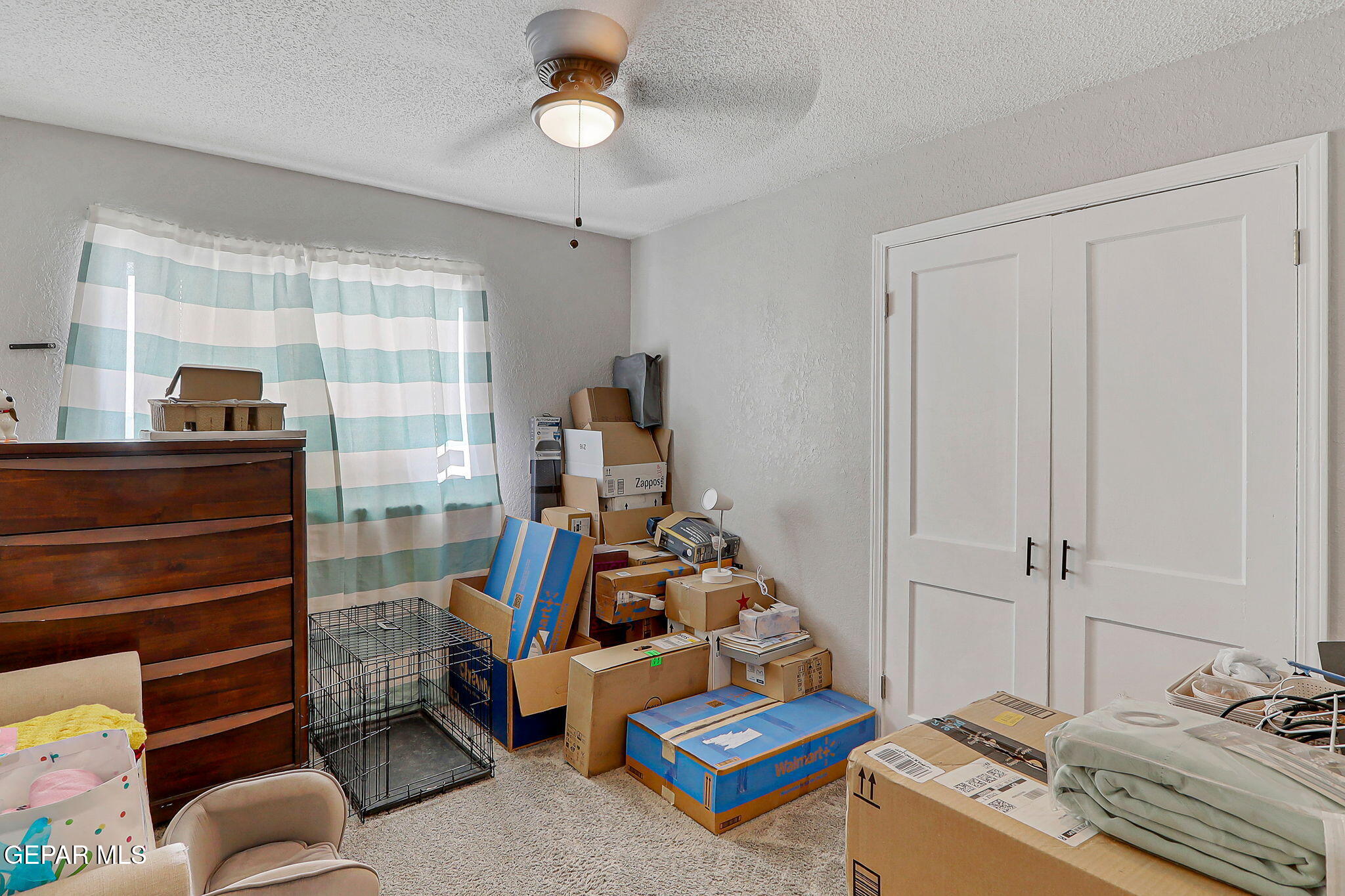 8339 White Road El Paso, TX 79907 - Photo 14 of 31 a bedroom with furniture and a gate