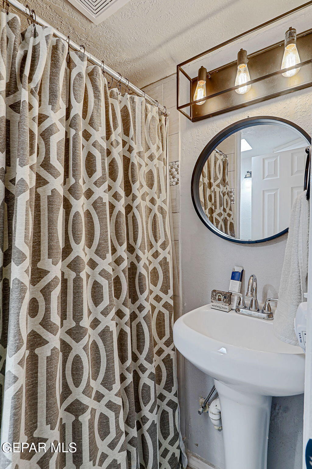 8339 White Road El Paso, TX 79907 - Photo 16 of 31 a bathroom with a sink and a mirror