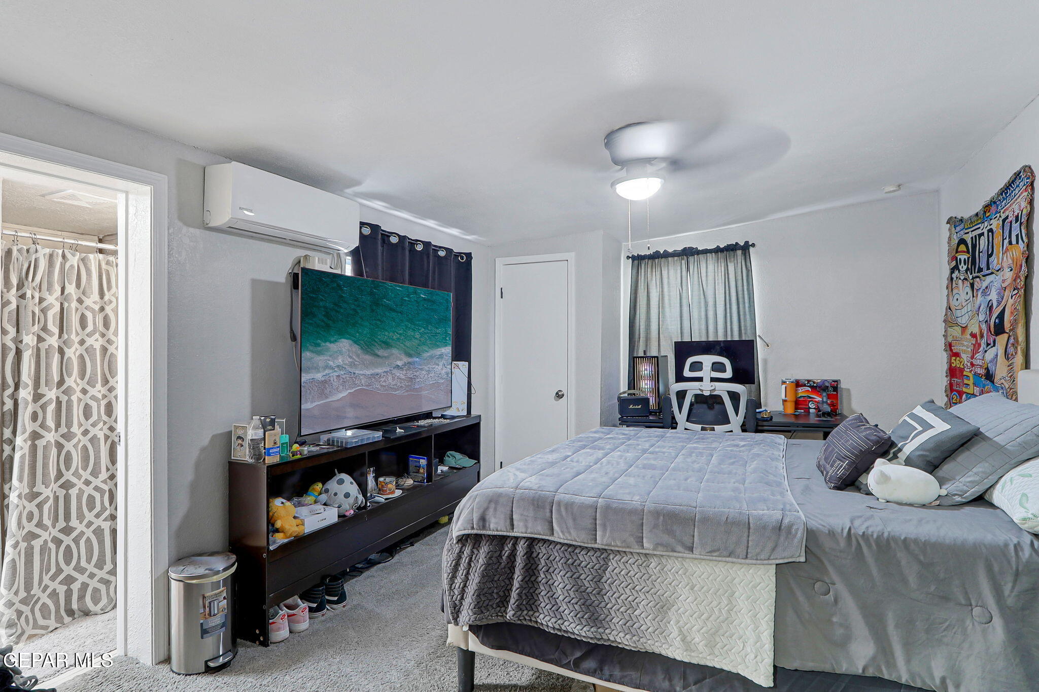 8339 White Road El Paso, TX 79907 - Photo 19 of 31 a bedroom with furniture and a flat screen tv