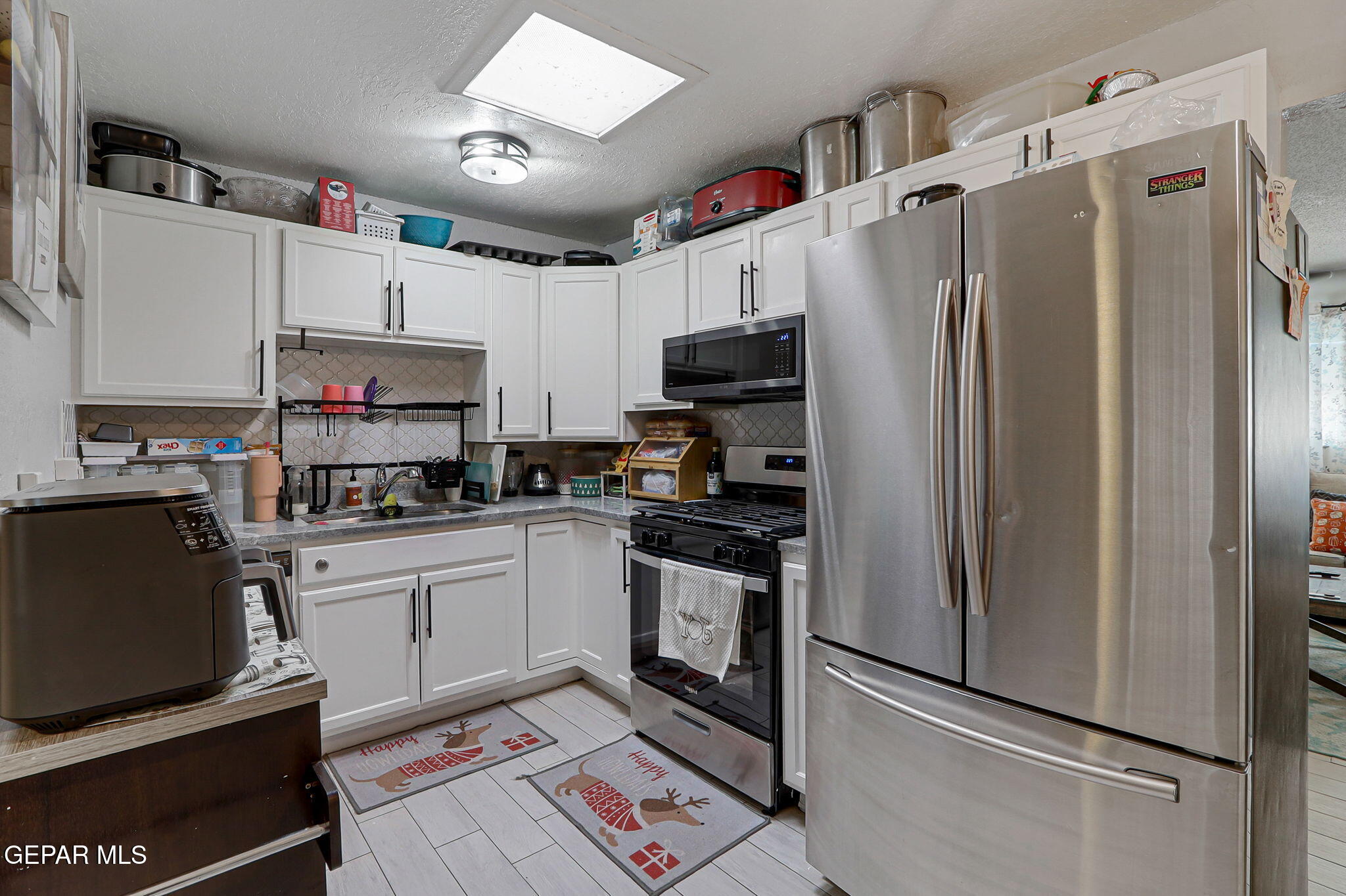 8339 White Road El Paso, TX 79907 - Photo 26 of 31 a kitchen with stainless steel appliances a refrigerator sink and microwave