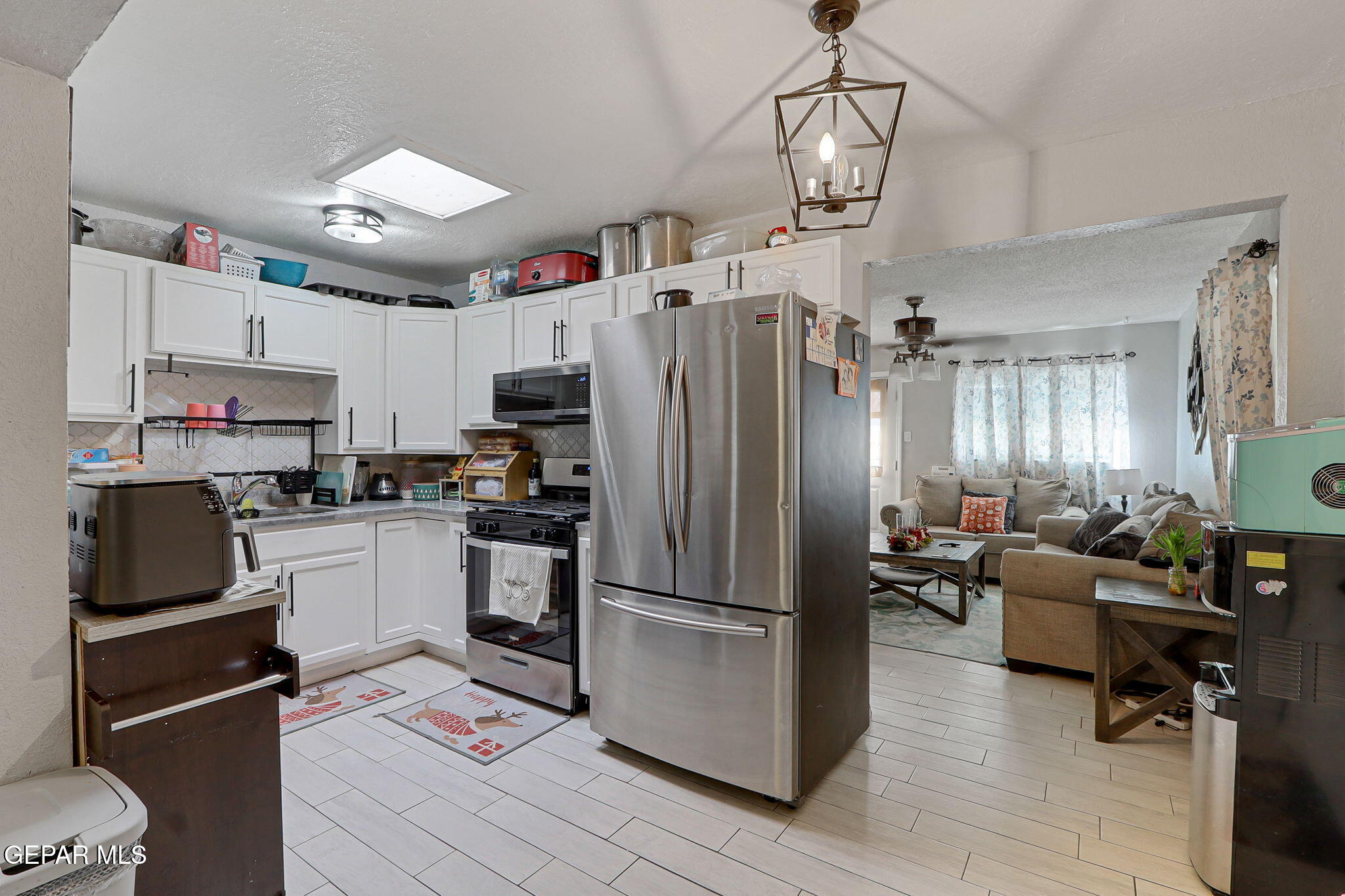8339 White Road El Paso, TX 79907 - Photo 27 of 31 a kitchen with kitchen island a counter top space appliances and cabinets