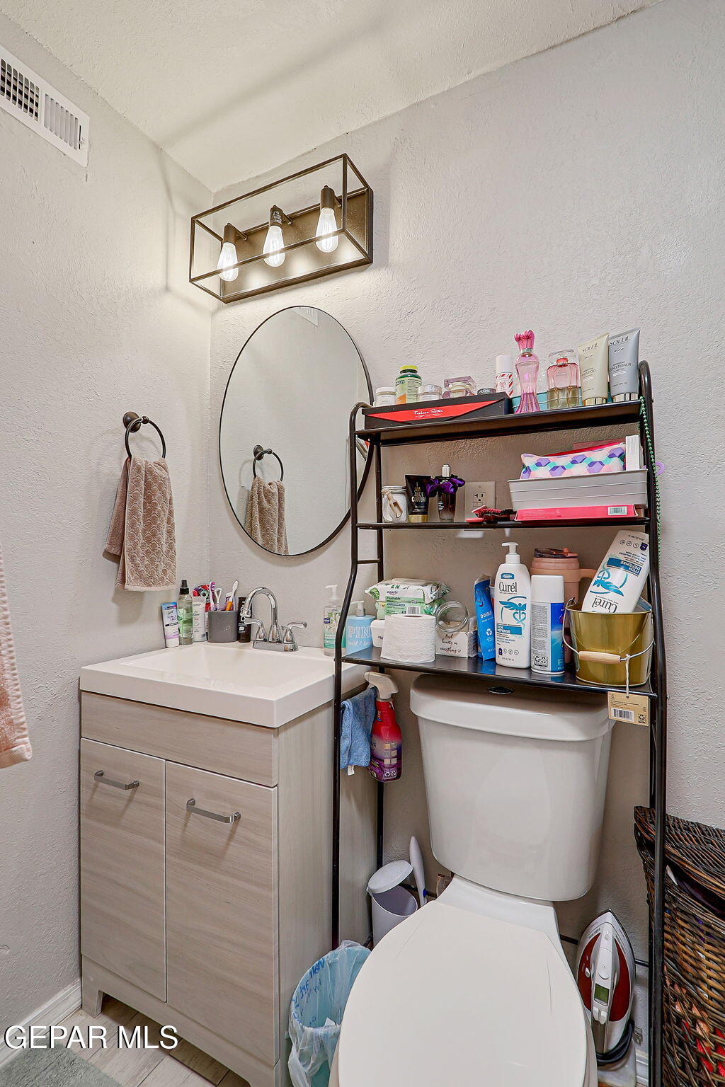 8339 White Road El Paso, TX 79907 - Photo 9 of 31 a bathroom with a sink mirror vanity and toilet